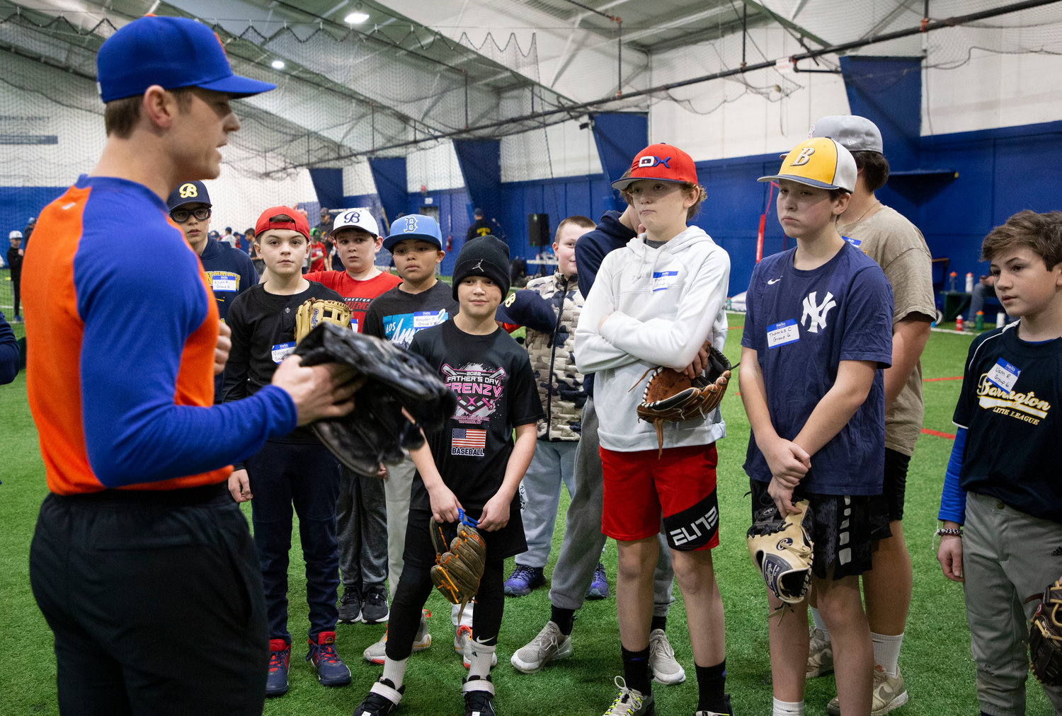 NY Mets pitcher David Robertson speaks to a group of baseball players about proper throwing stance during a special skills clinic last weekend.