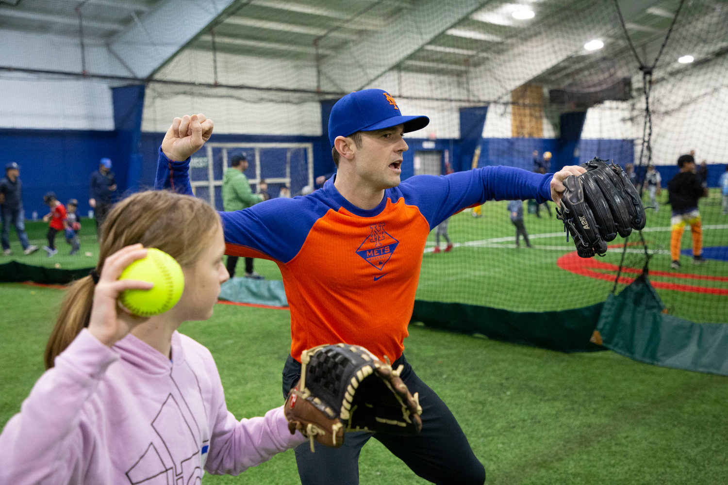 Barrington resident and NY Mets pitcher David Robertson shares throwing tips with a group of Barrington Little League softball and baseball players during a special pre-season clinic on Sunday.