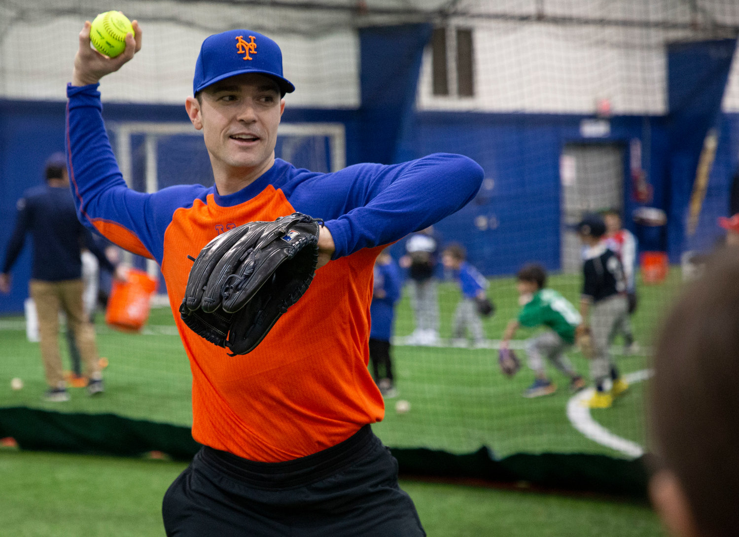 Barrington resident and NY Mets pitcher David Robertson shares throwing tips with a group of Barrington Little League softball and baseball players during a special pre-season clinic on Sunday.