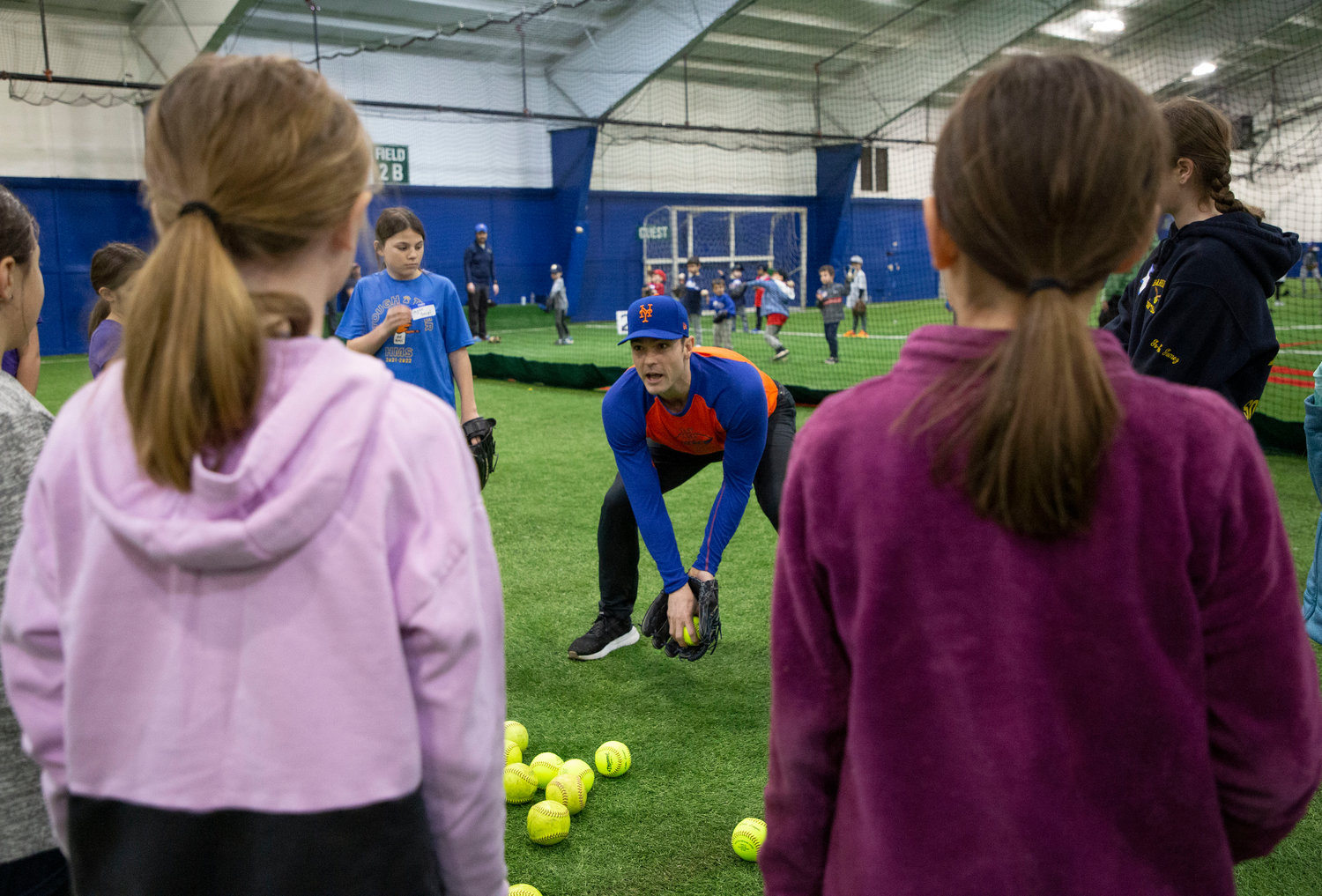 Barrington resident and NY Mets pitcher David Robertson shares fielding tips with a group of Barrington Little League softball and baseball players during a special pre-season clinic on Sunday.