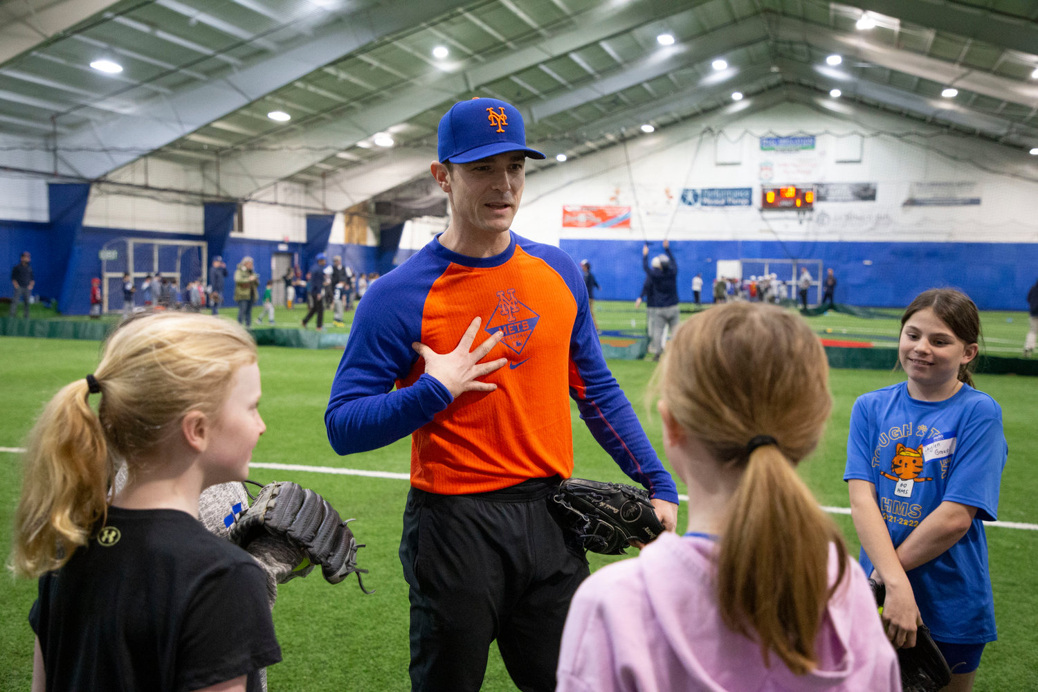 Barrington resident and NY Mets pitcher David Robertson shares throwing tips with a group of Barrington Little League softball and baseball players during a special pre-season clinic on Sunday. A large group of local Little Leaguers attended the event, which was held at TeamWorks in Seekonk.
