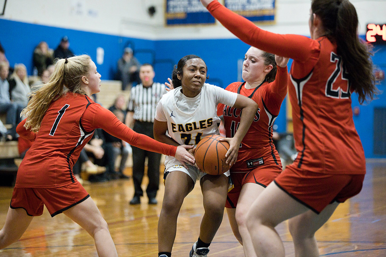 Janaya Prince-Baquero squeezes through a trio of Cranston West defenders while controlling the ball for the Eagles.