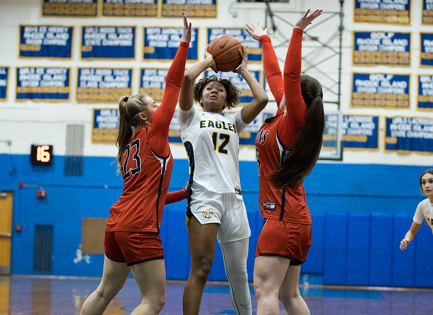 Lindsey Lemay is pressured by a pair of Cranston West defenders while looking to shoot.