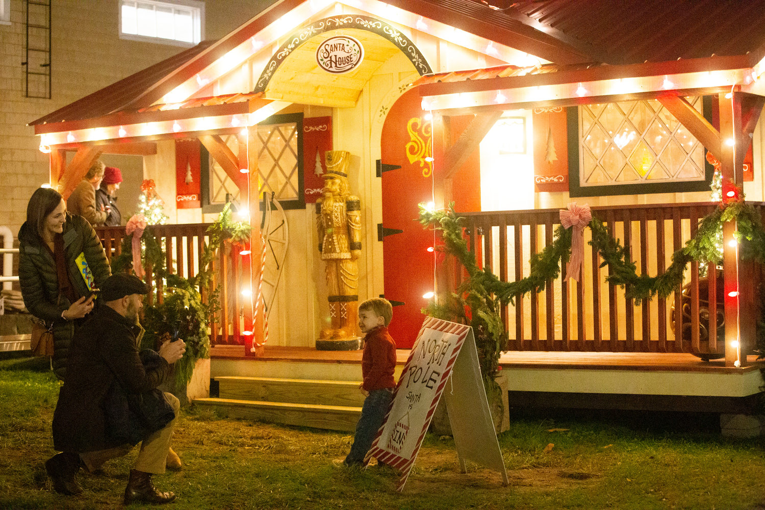 A family takes a picture in front of the Santa House on State Street during its inaugural opening this past December.