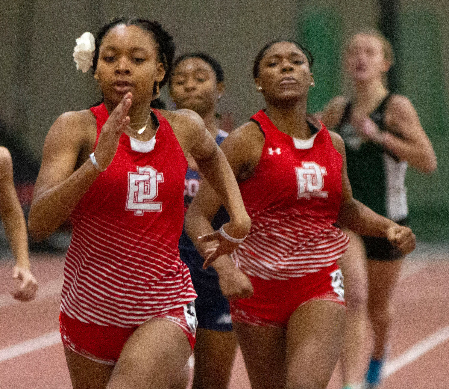East Providence High School's Nazarae Phillip, at left and en route to winning the 300 meters in a regular season meet earlier this winter just ahead of teammate Kandace Daniel, captured that event and the 55 dash last week during the Sullivan Division championship meet.