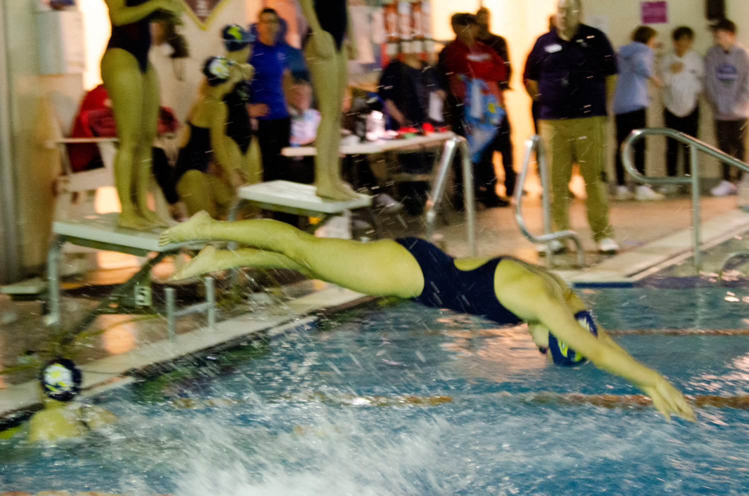 A Barrington swimmer dives into the water during the 200 free relay.