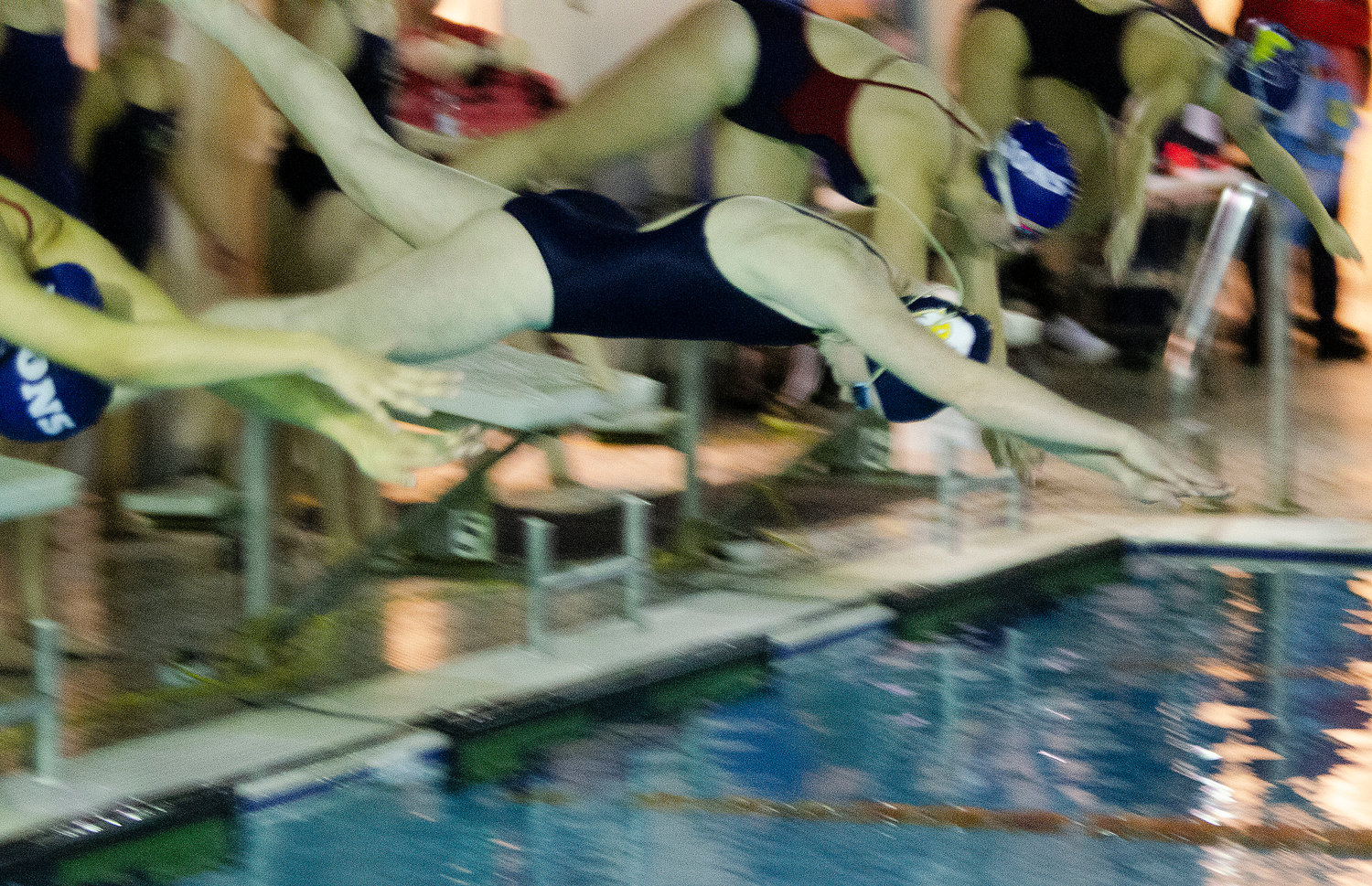 A Barrington swimmer dives into the water during the 200 free relay.