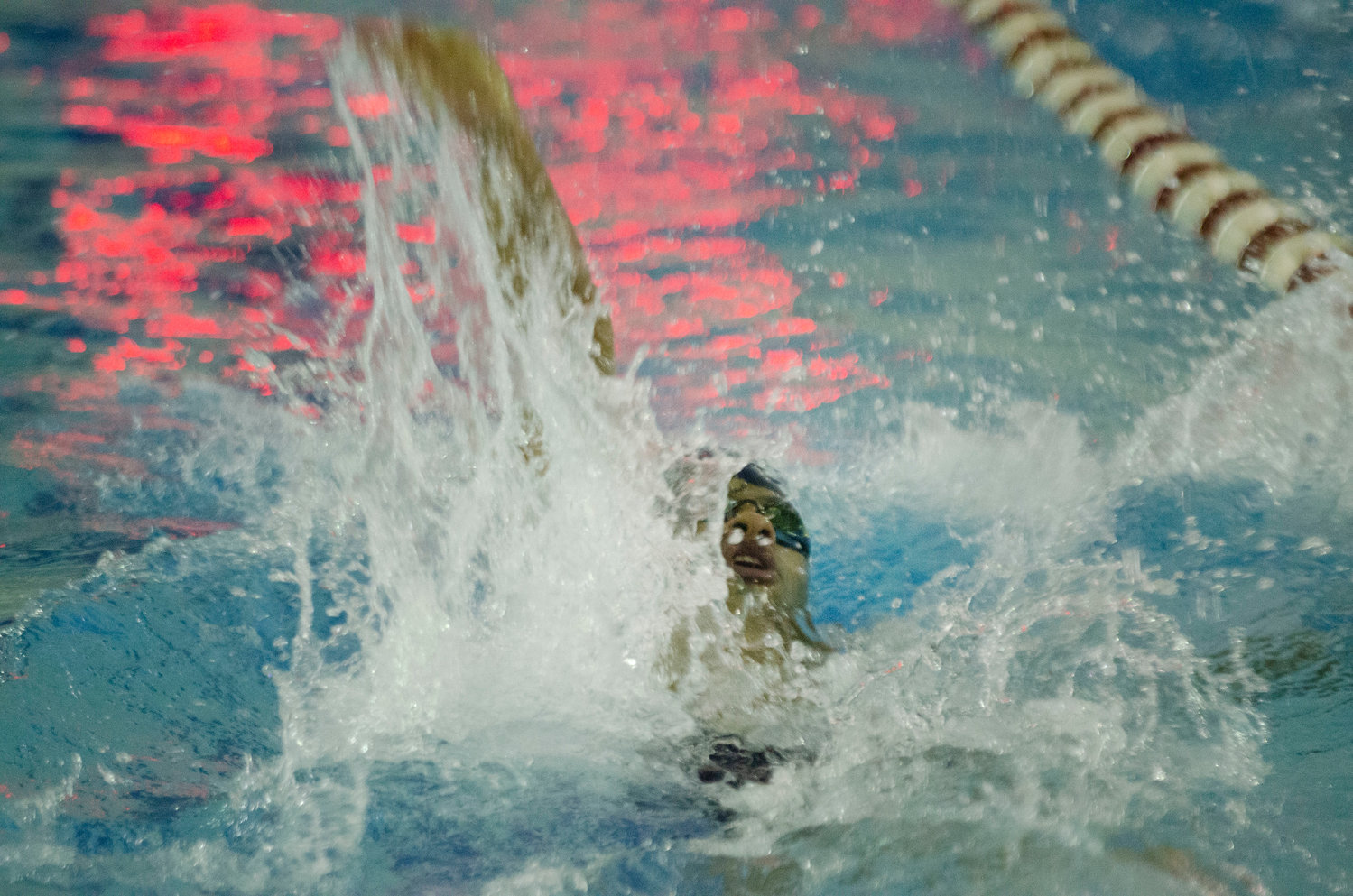 Lucas Jauregui swims the backstroke during Barrington's meet against Lincoln.