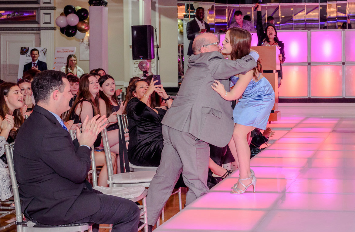 Ela Pirri hugs her dad, Robert, during her turn on the runway at the third annual Limb Kind Foundation’s “Show Your Shine” event in New York.