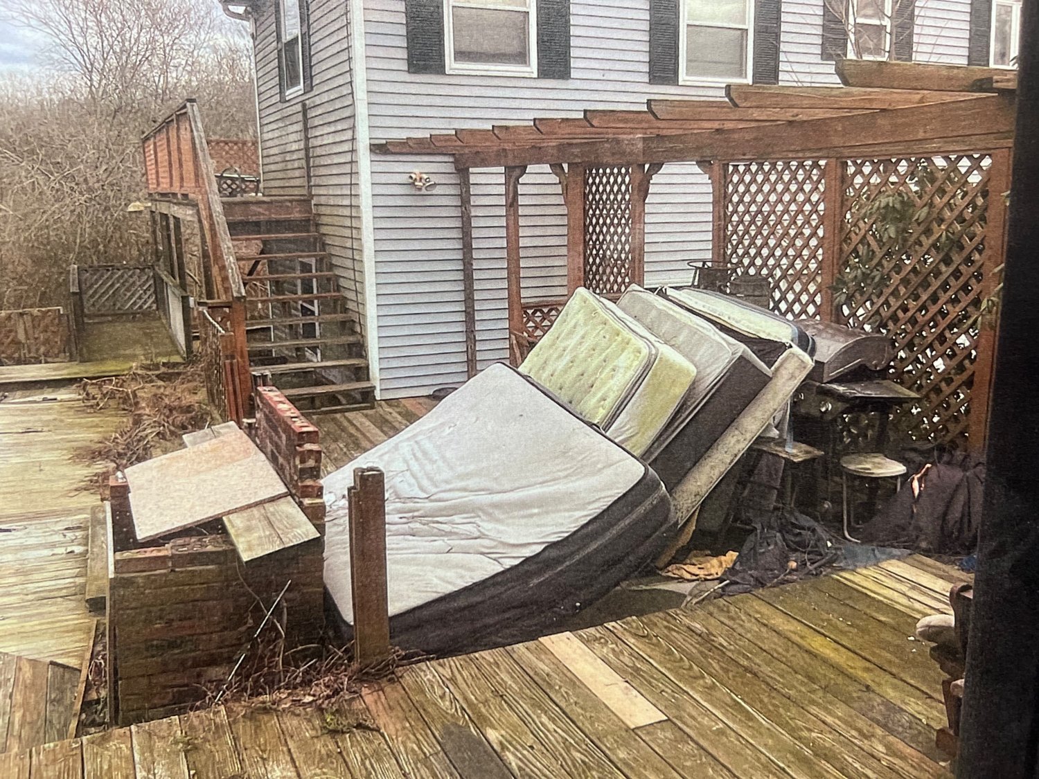 The house had been on the Town’s radar for over a year following reports of large amounts of debris throughout the property’s exterior. Here, multiple mattresses are seen stacked in an area outside.