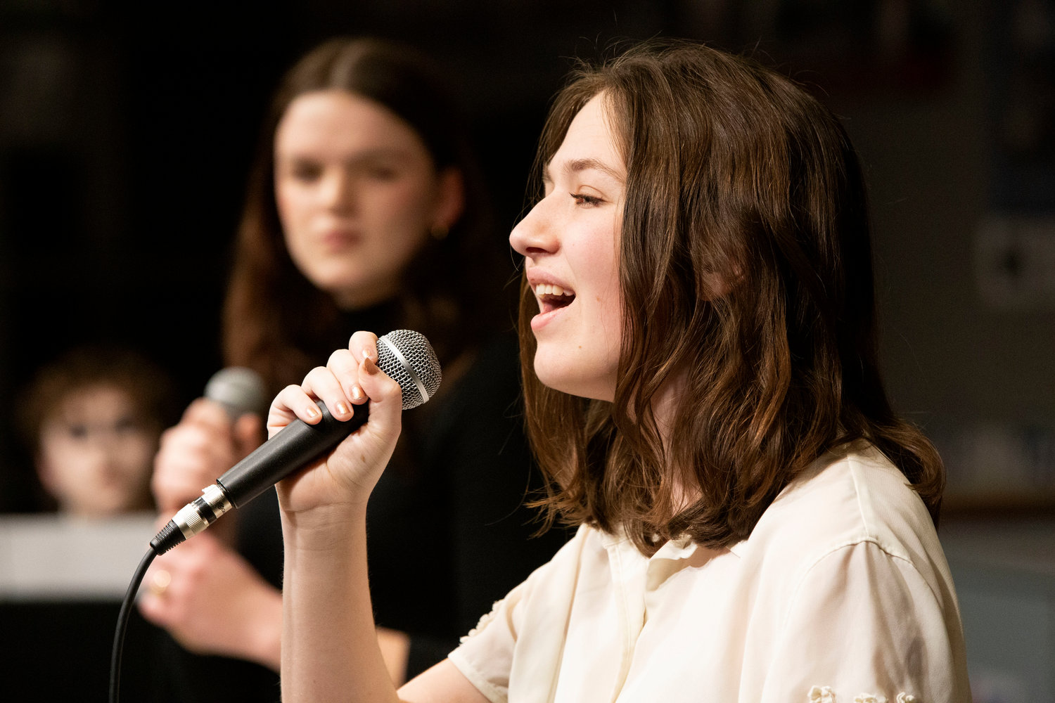 Mia Shaw (left) and Seren Davies sing the duet, Man or a Muppet, with Vic Bullard on the piano.