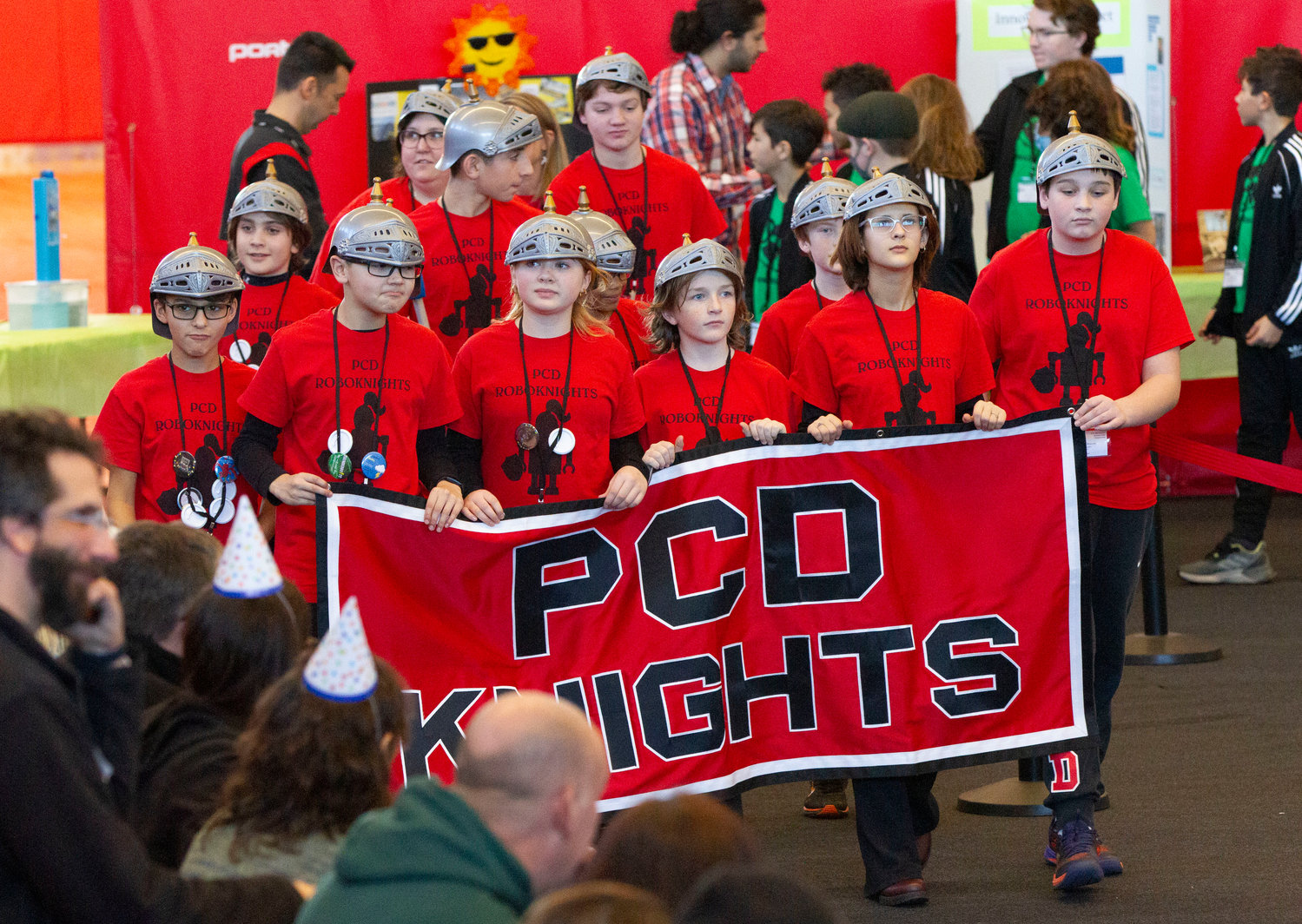The “Roboknights” from the Providence Country Day School enter the gym during the opening ceremonies.