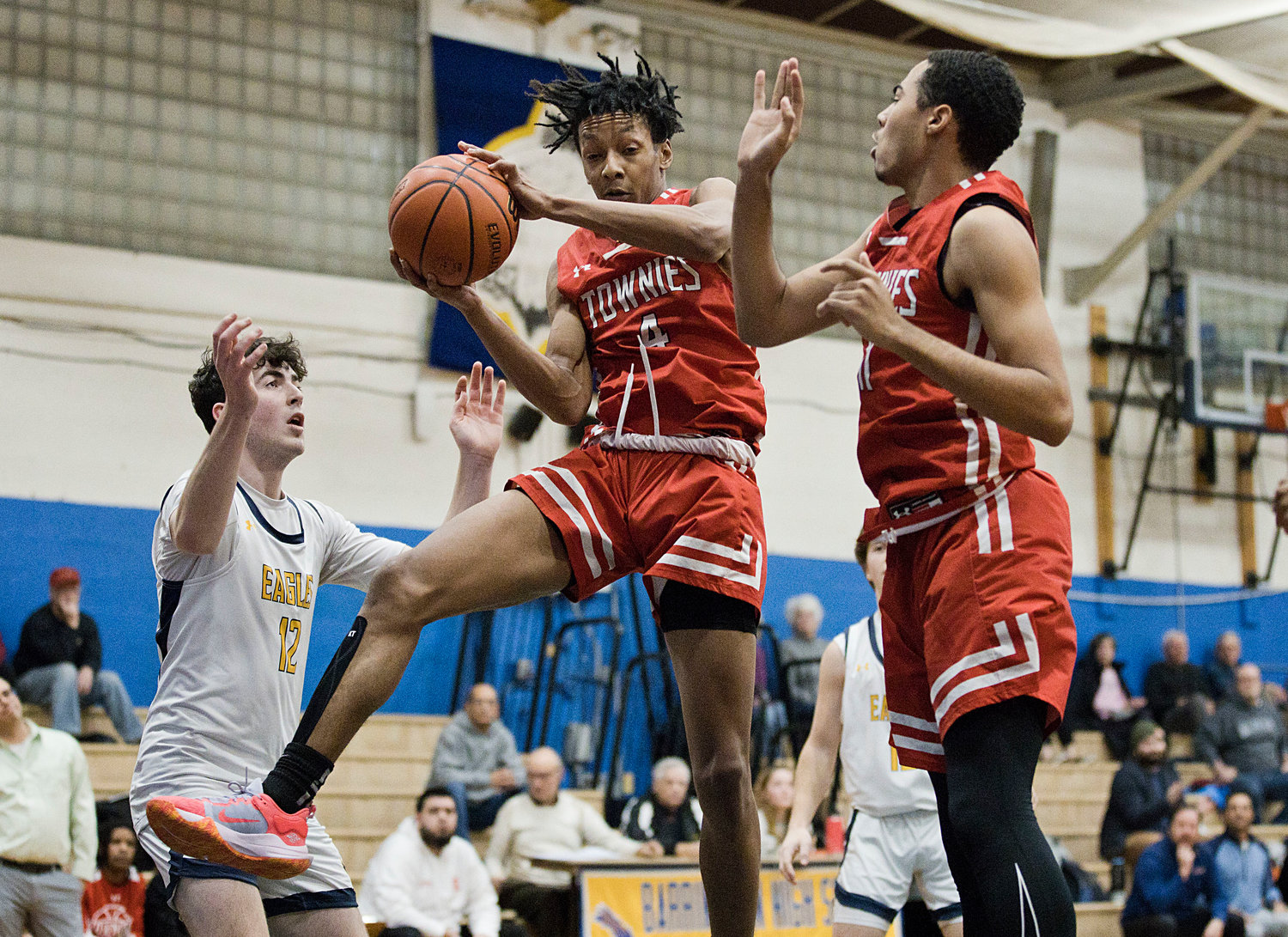 East Providence's Kemerie Dublin (left) and Will Winfield pull down a rebound from Barrington's Dan Coogan.