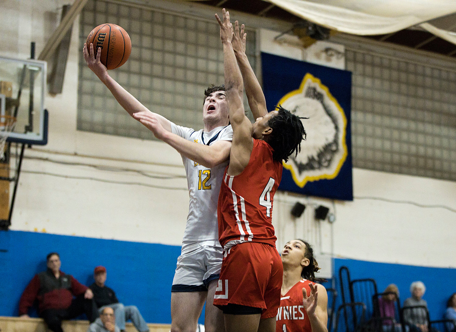 Dan Coogan goes up for a shot while guarded closely by an East Providence defender.
