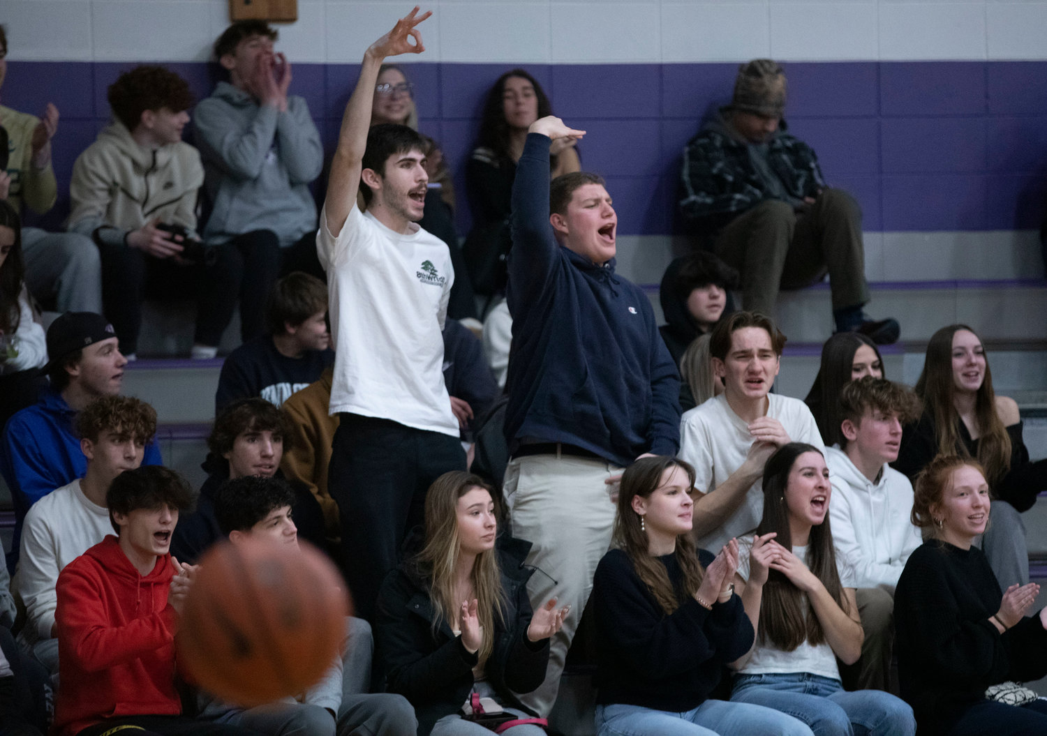 James Rustici, George Piper, Jamison Canario and the dog pound cheer on the Huskies.