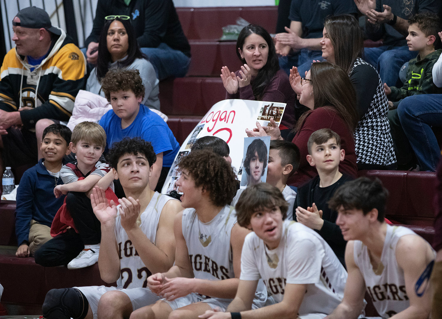 Nate Sama, Tristan White, Logan Bouchard and Ben Pacheco cheer on their teammates as they take a breather in the third quarter.