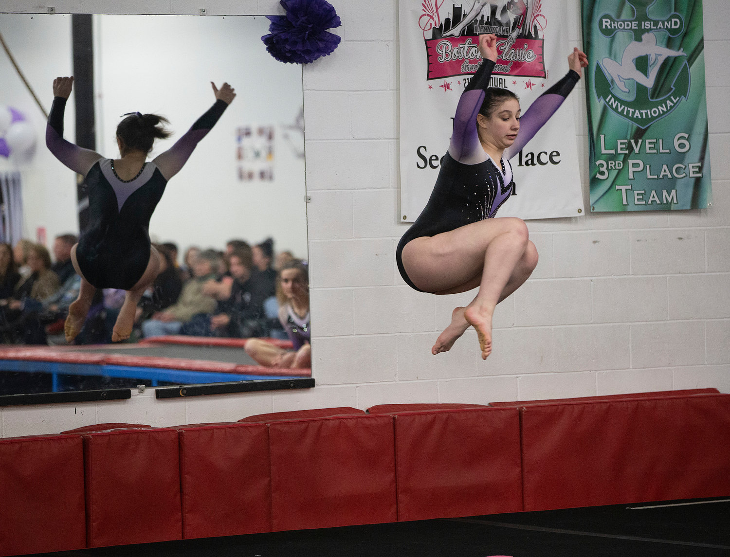 Isabella Brando performs a jump during her floor routine.