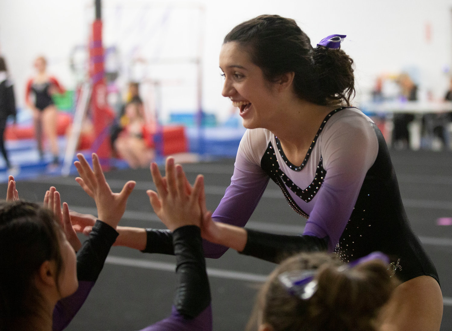 Thalyta Pereira receives high fives after her floor routine.