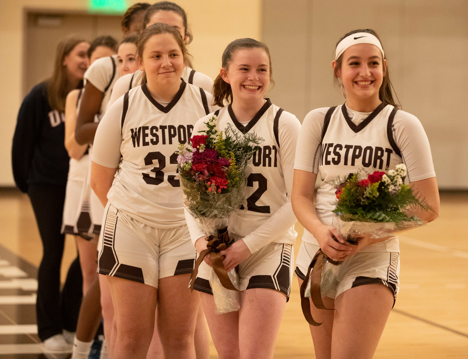 Co-captain Sarah Perry (left) looks on with seniors Shelby Orr (middle) and Leah Sylvain as head coach Jen Gargiulo speaks proudly about her two seniors.