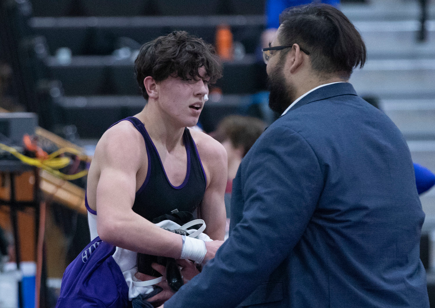 A beleaguered Mason Furtado shakes hands with head coach Ryan Fazzi after he lost a consolation round match to James Rocco of Barrington. Furtado placed sixth in the state.
