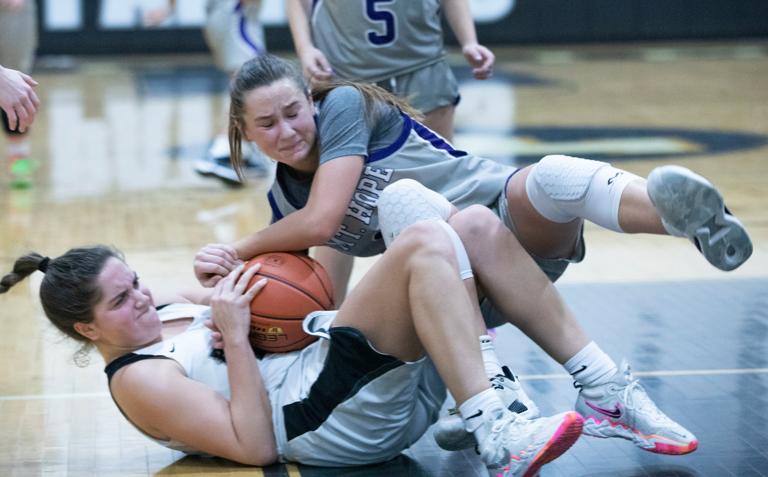 Reyn Ferris fights for a loose ball during the Huskies' preliminary playoff game at Pilgrim on Monday night. Mt Hope lost the game 53-47.