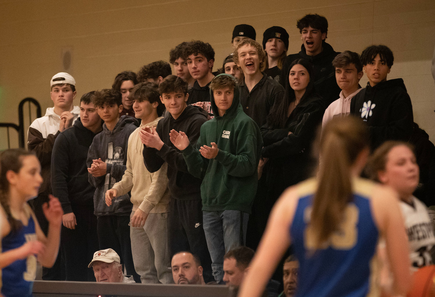 Members of the boys basketball team cheers on the Wildcats.