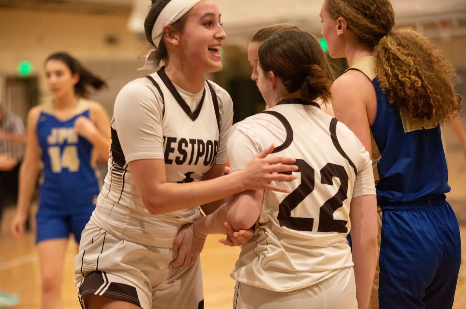 Leah Sylvain cheers on Shelby Orr after she sank a basket and collected a free throw.