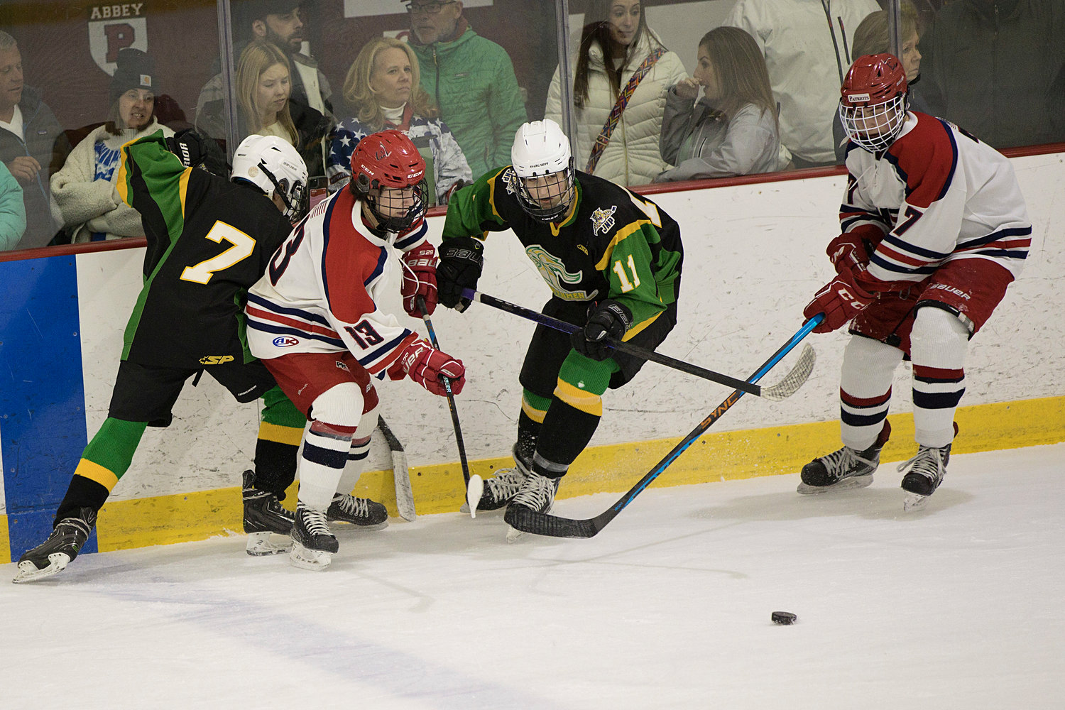 Ben West (left) and Connor Rogers battle for possession of a loose puck.