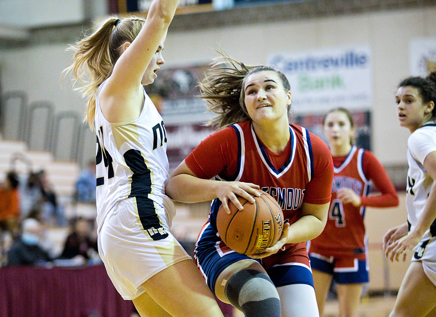 Portsmouth High’s Emily Maiato barrels through the North Kingstown defense to get under the basket during Saturday’s “Elite Eight” game on the road, which the Patriots lost to end their season.