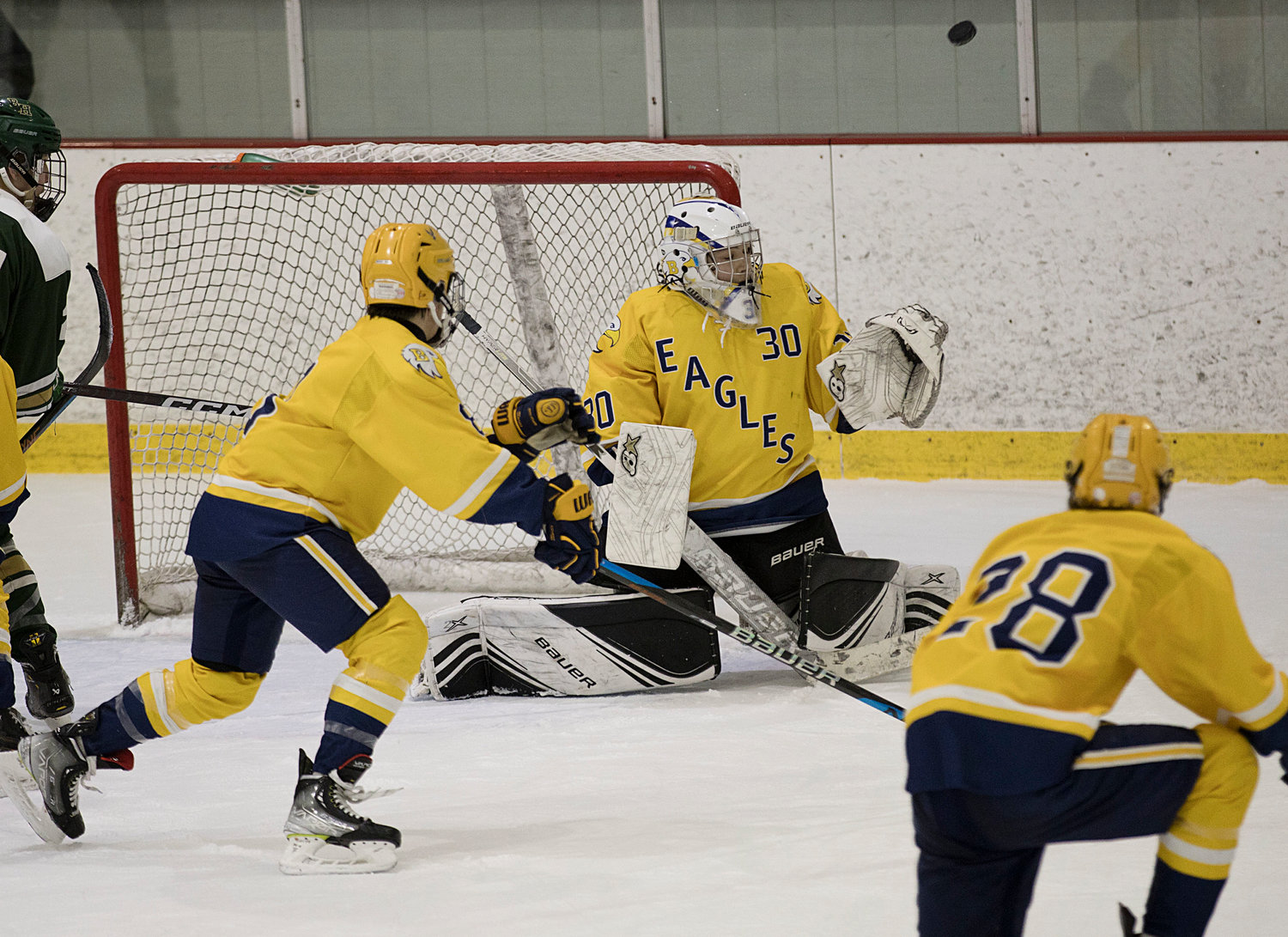 Goalie Dominic Bruzzi deflects a shot while battling Hendricken in game two of the Division 1 quarterfinals, Sunday.