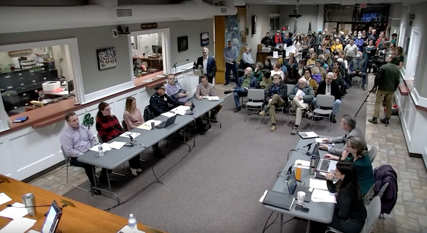 A screen grab from the Town Council meeting's recording on YouTube shows a standing room only crowd as Robert Botelho speaks at the podium.