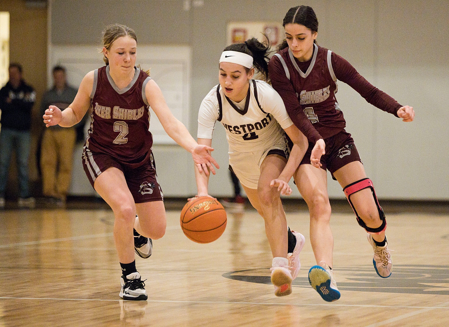Leah Syvain splits a pair of defenders while advancing the ball toward the hoop. 