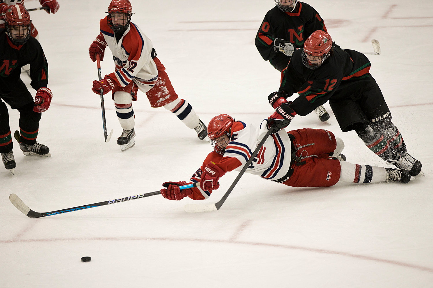 Finn O’Connor reaches for the puck after colliding with a Narragansett opponent.