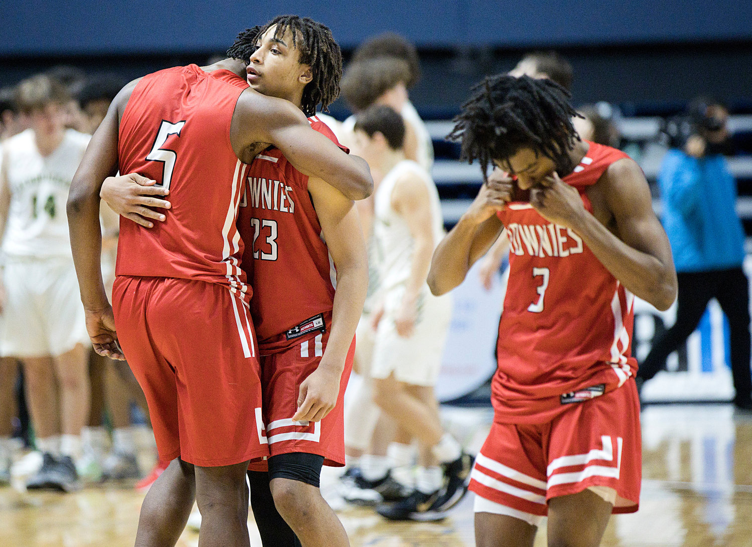 Townies Kenaz Ochgwu and Xavier Hazard (left), Trey Rezendes (right) walk off the floor after their seven-point loss to Hendricken in the state semis Saturday, March 11.