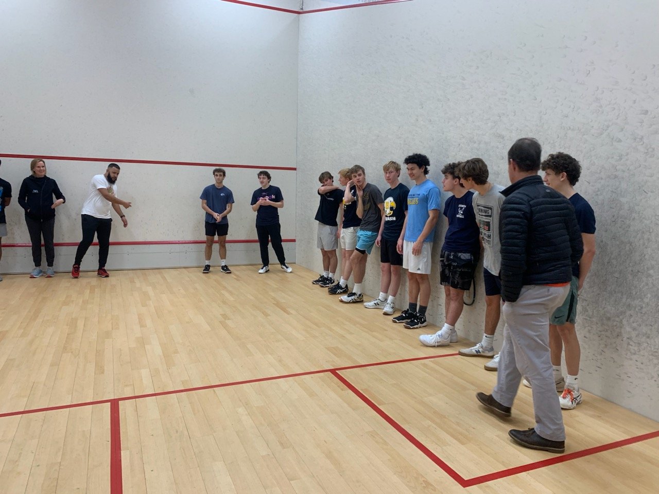 Members of the Barrington High School Squash Club pick up some instruction earlier this season.