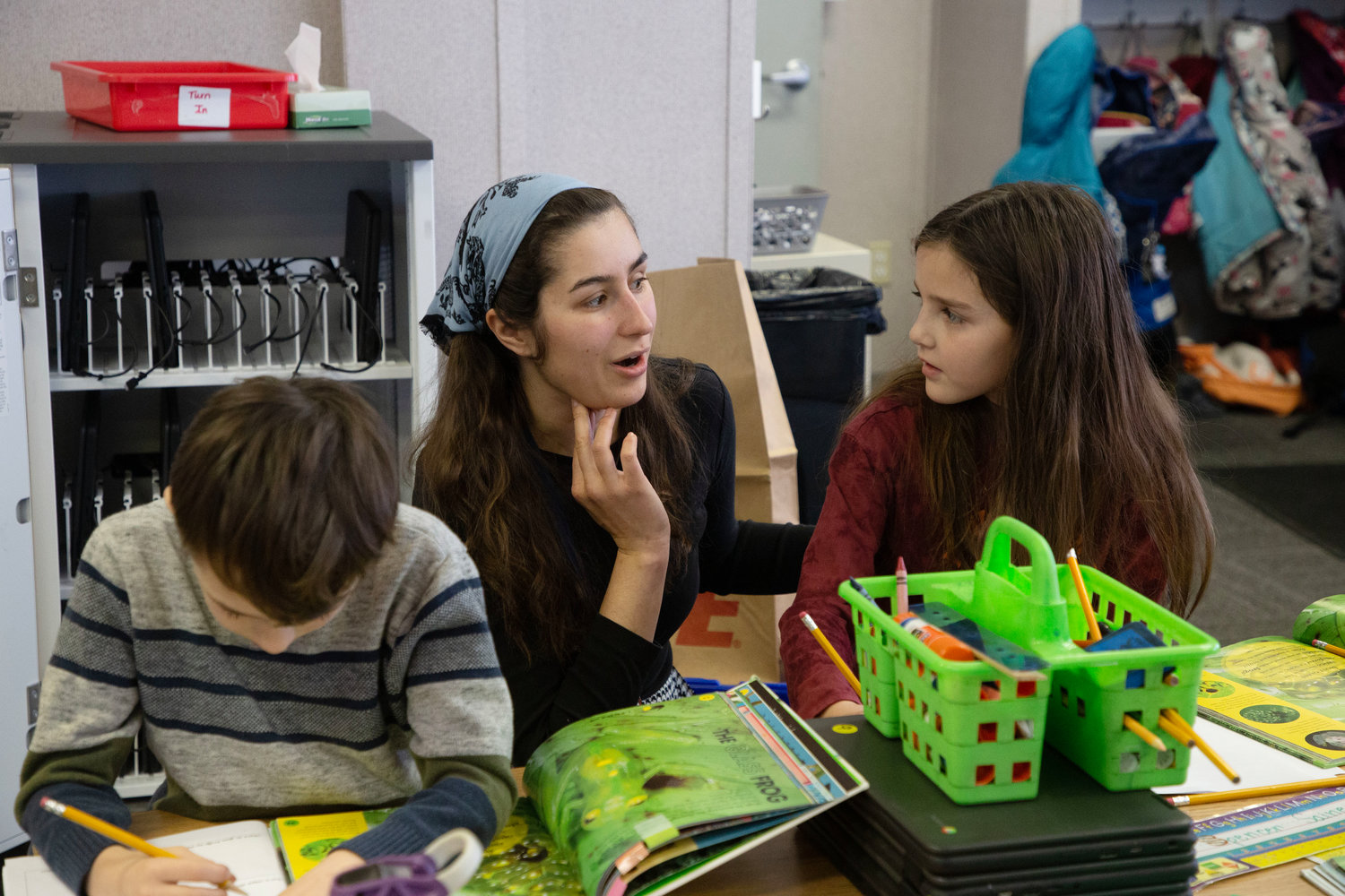 Primrose Hill School third grade teacher Abigail Canto works with one of her students. Canto’s class recently moved from a temporary space in the cafeteria into a new modular unit.