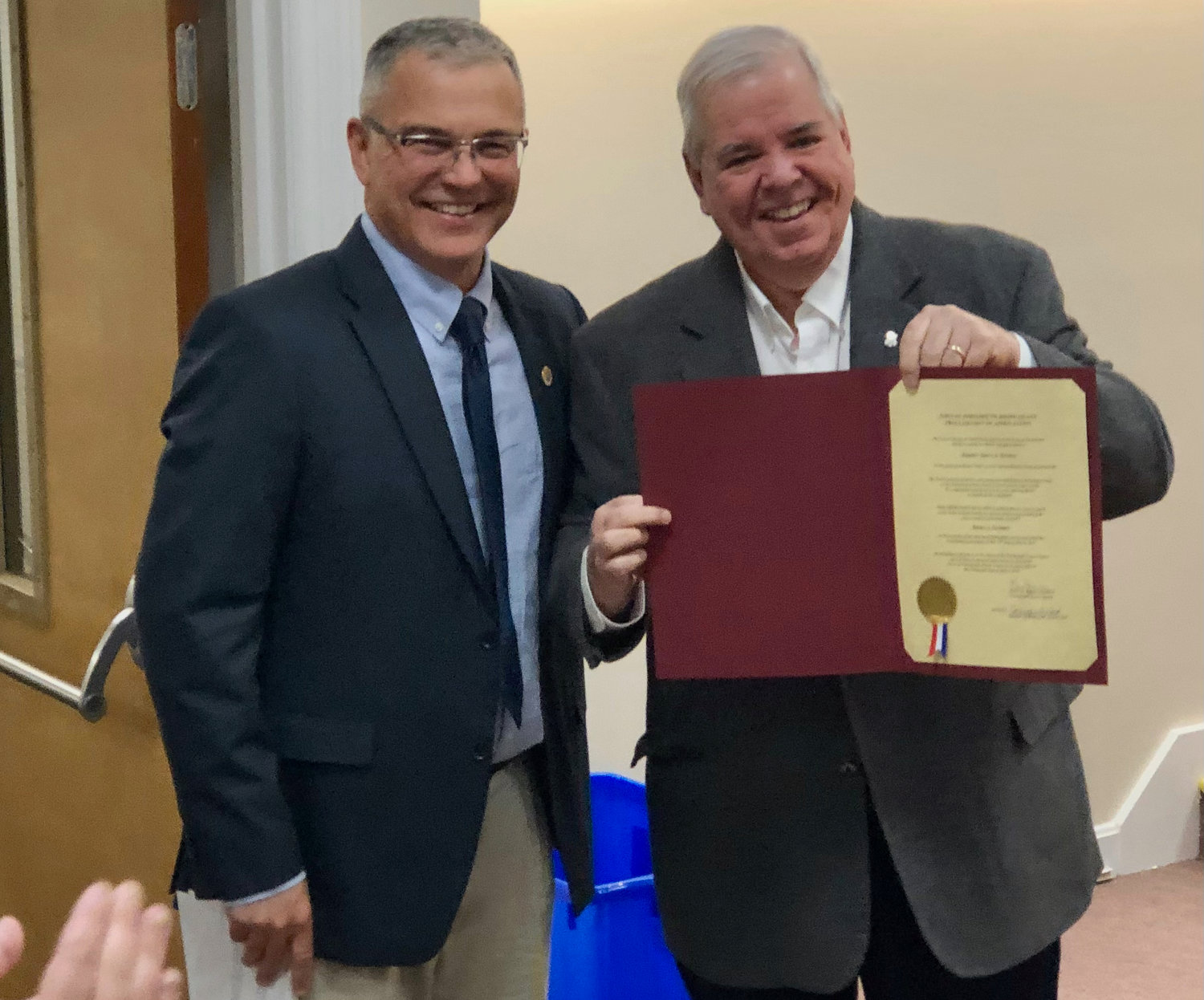 Former R.I. Sen. James Seveney shows off the proclamation that Town Council President Kevin Aguiar (left) had just presented to him during a brief ceremony at Monday night’s meeting. Seveney is also a former council president.