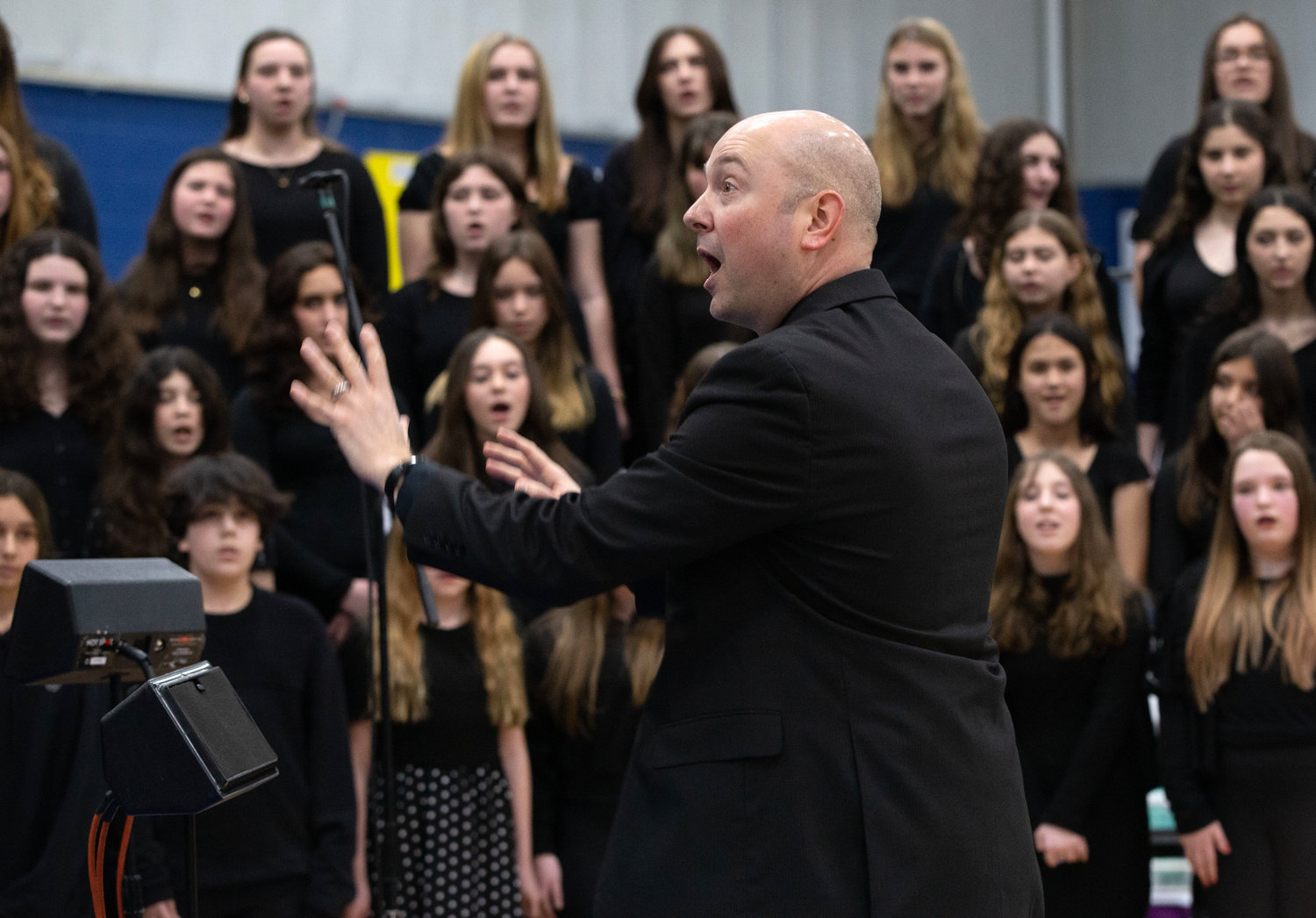 Kickemuit Middle School chorus director Andre Arsenault leads the chorus in “Give Us Hope.”
