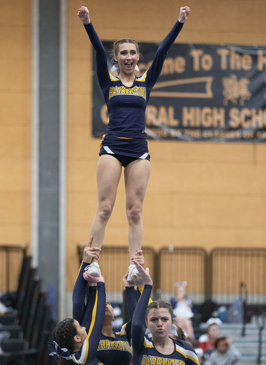 Barrington’s Kaleigh Moran (top) and her teammates perform at the Rhode Island Interscholastic League Division II Cheer Competition.