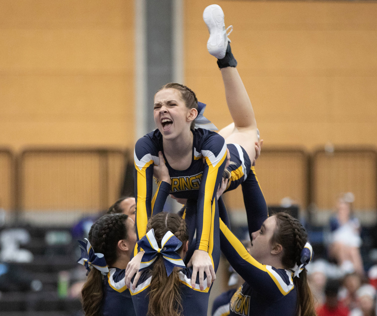 Teammates lift Morgane Seadale during a stunt at the Rhode Island Interscholastic League Division II Cheer Competition.