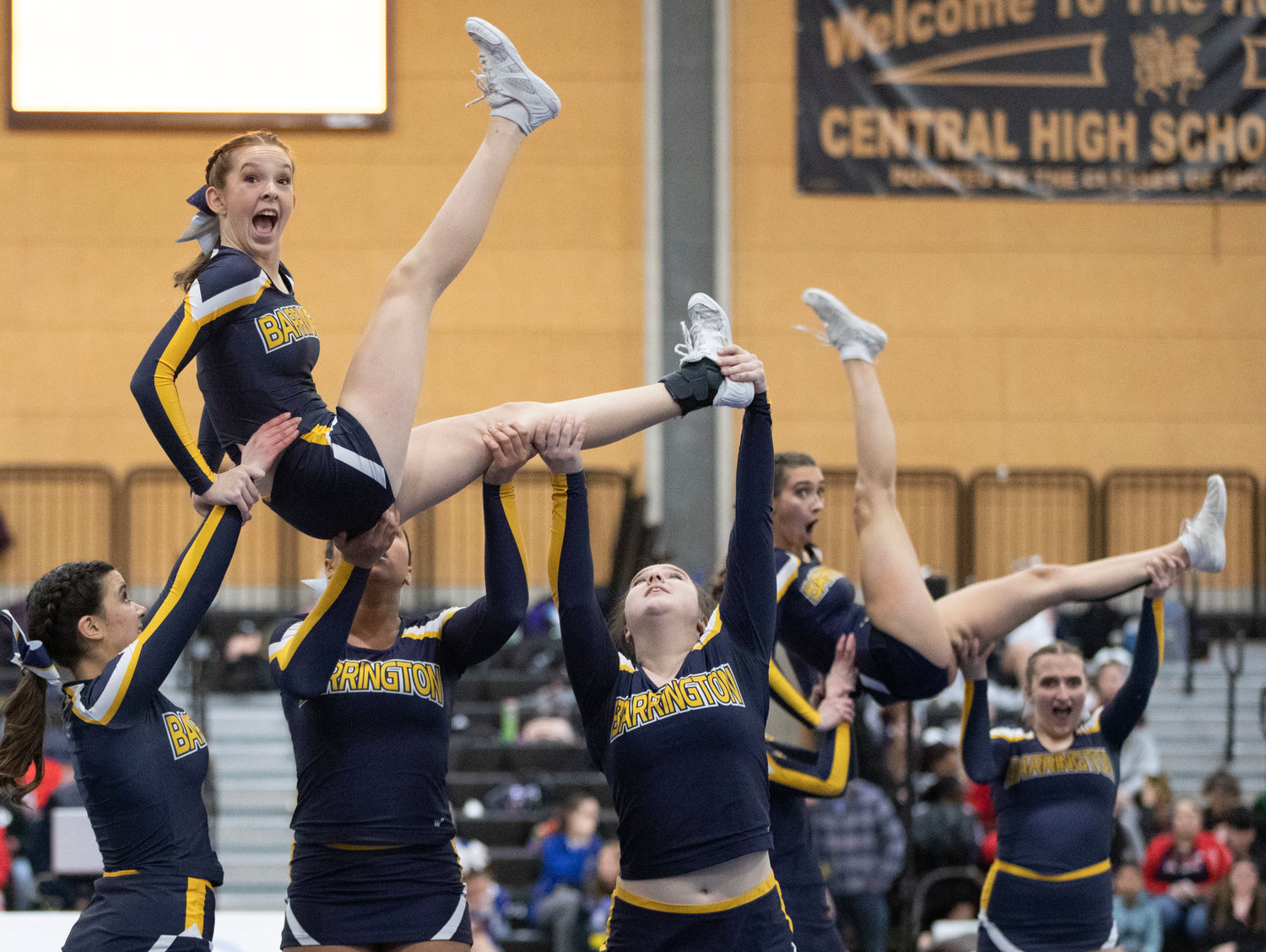 Teammates lift Morgane Seadale during a stunt at the Rhode Island Interscholastic League Division II Cheer Competition.