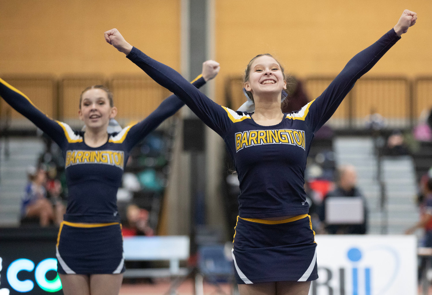 Sarah Simon (right) and Morgane Seadale (left) lead a cheer at the Rhode Island Interscholastic League Division II Cheer Competition.