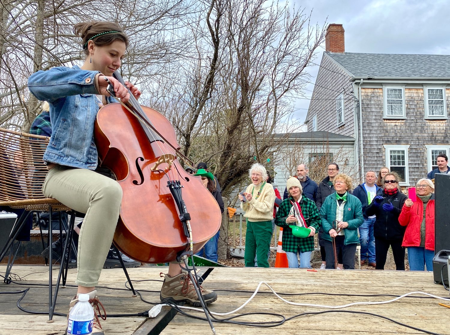 Polly Gardner (center rear), bass player and singer for the Spindle Rock River Rats, gets into the music as Scottish Fish performs during the parade.