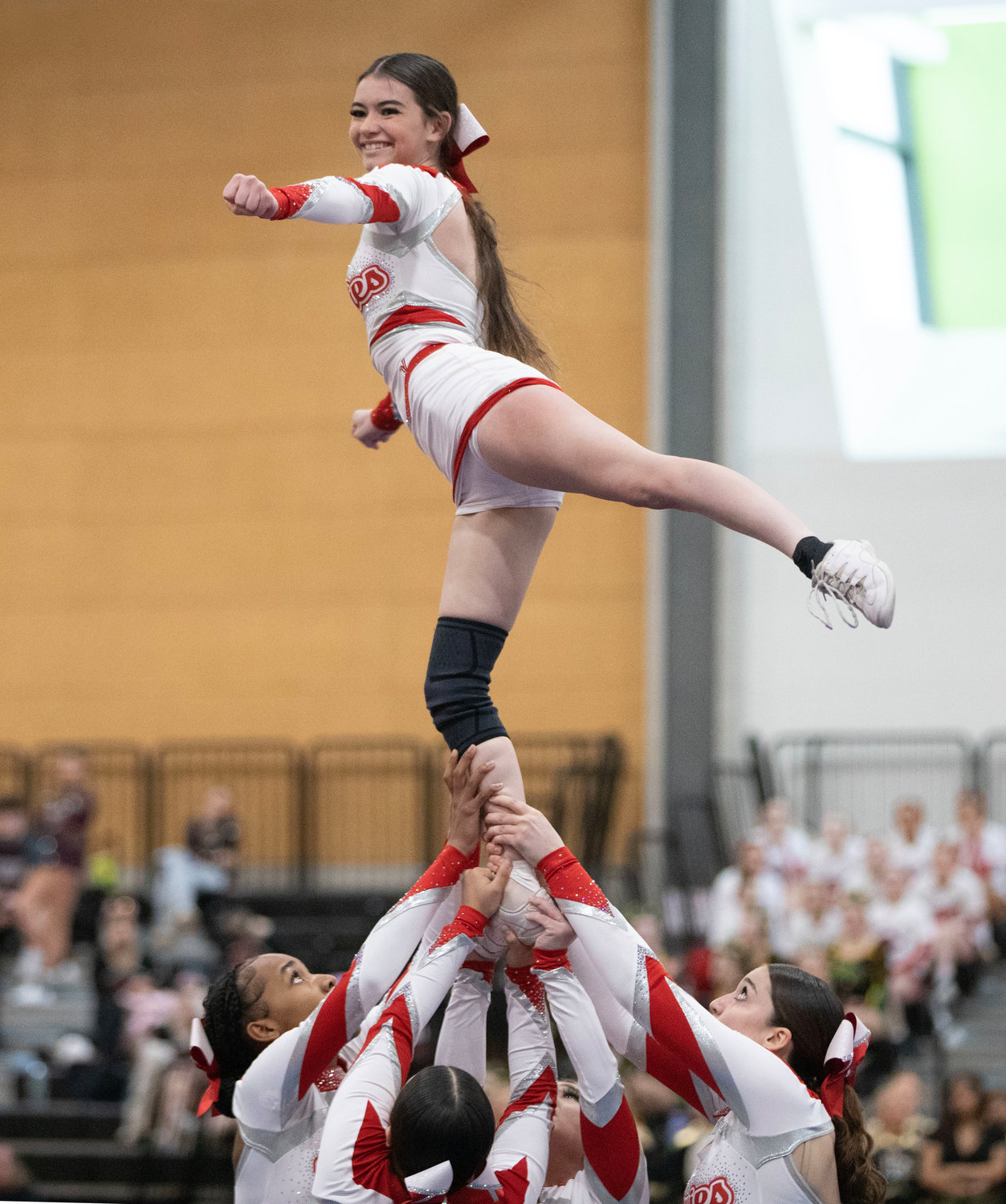 Mackenzie Pacheco performs a stunt atop her teammates.