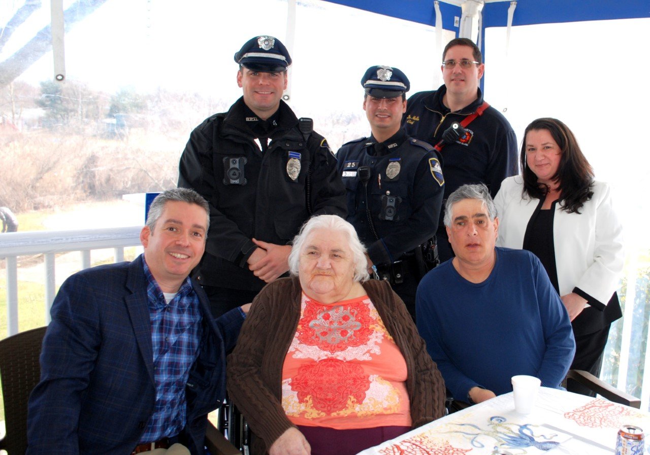 Longtime Bristol resident Mary Vieira (seated center) was honored last week at a special luncheon at the Silver Creek Rehab and Healthcare Center. Joining in were (back row, standing l-r): Patrolman Sean Gonsalves, Patrolman Angelo Greco, Fire Chief Michael A. DeMello, and Silver Creek Administrator Sharon Fusco. Flanking Ms. Vieira are Town Administrator Steve Contente (left) and Ms. Vieira's son, Stephen Vieira.