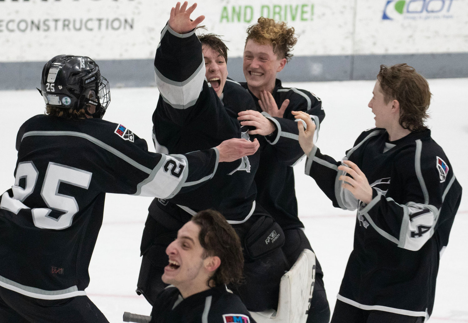 Teammates celebrate with Max Braun (mid-right) after the victory.