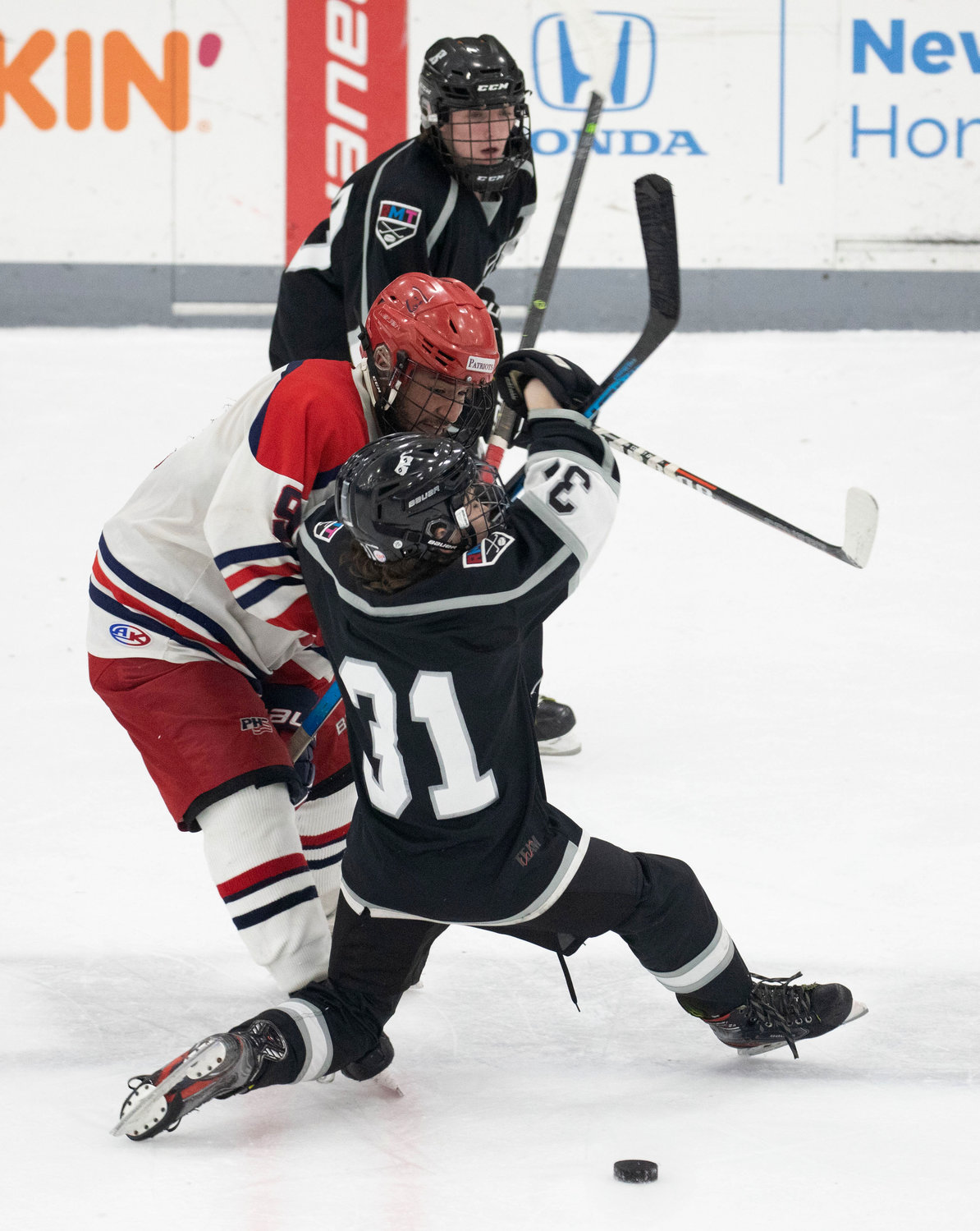 Portsmouth defenseman James LeBreux takes down Hurricanes forward Brayden Swanycamp at mid ice in the second period.