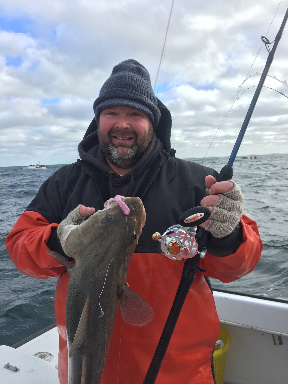 Capt. Peter Bacon of Big Game Charters with cod fish. The charter boat company booked many offshore and inshore fishing trips at the New England Saltwater Fishing Show last weekend.
