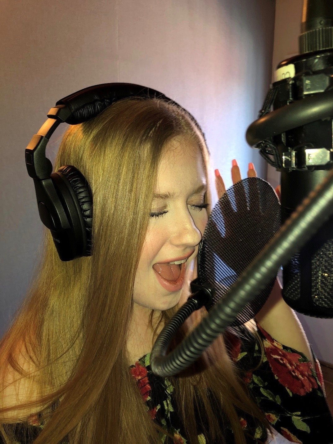 Jessica Kaela, shown in studio singing her newly released single, “Crying.”