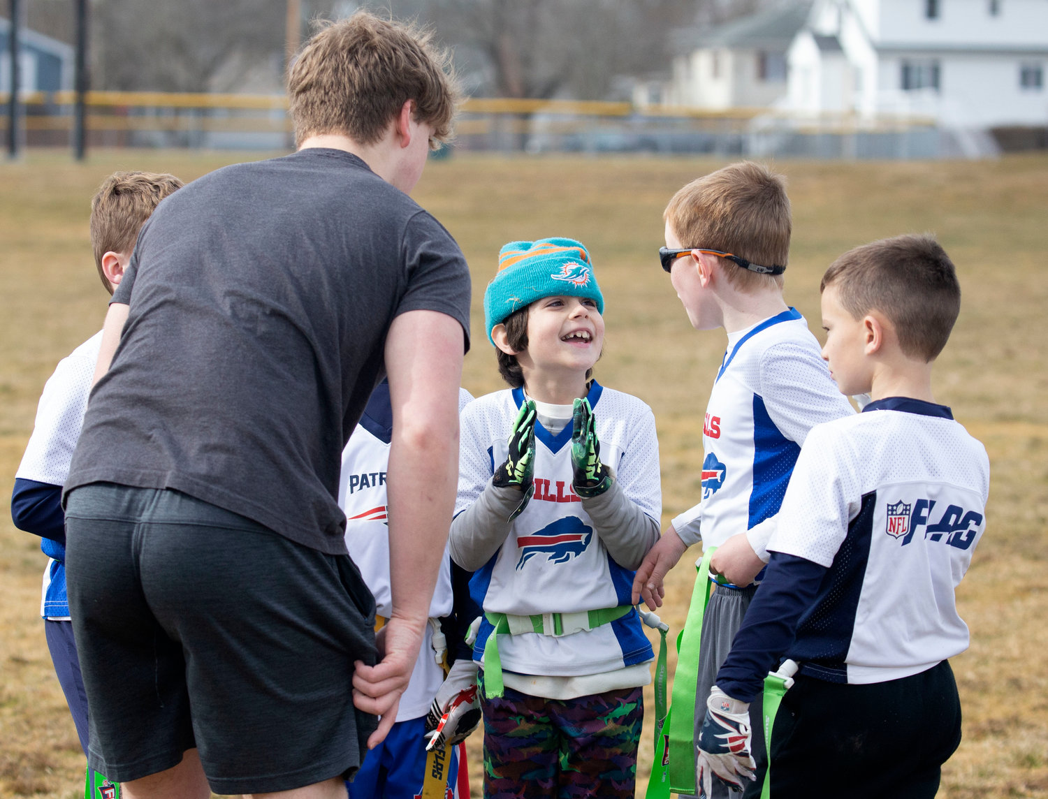 Ben McClelland, a student at Barrington High School, helps coach a team at the flag football tournament which was organized by Ryan O’Connell and Harrison Cooley as part of their Senior Projects.